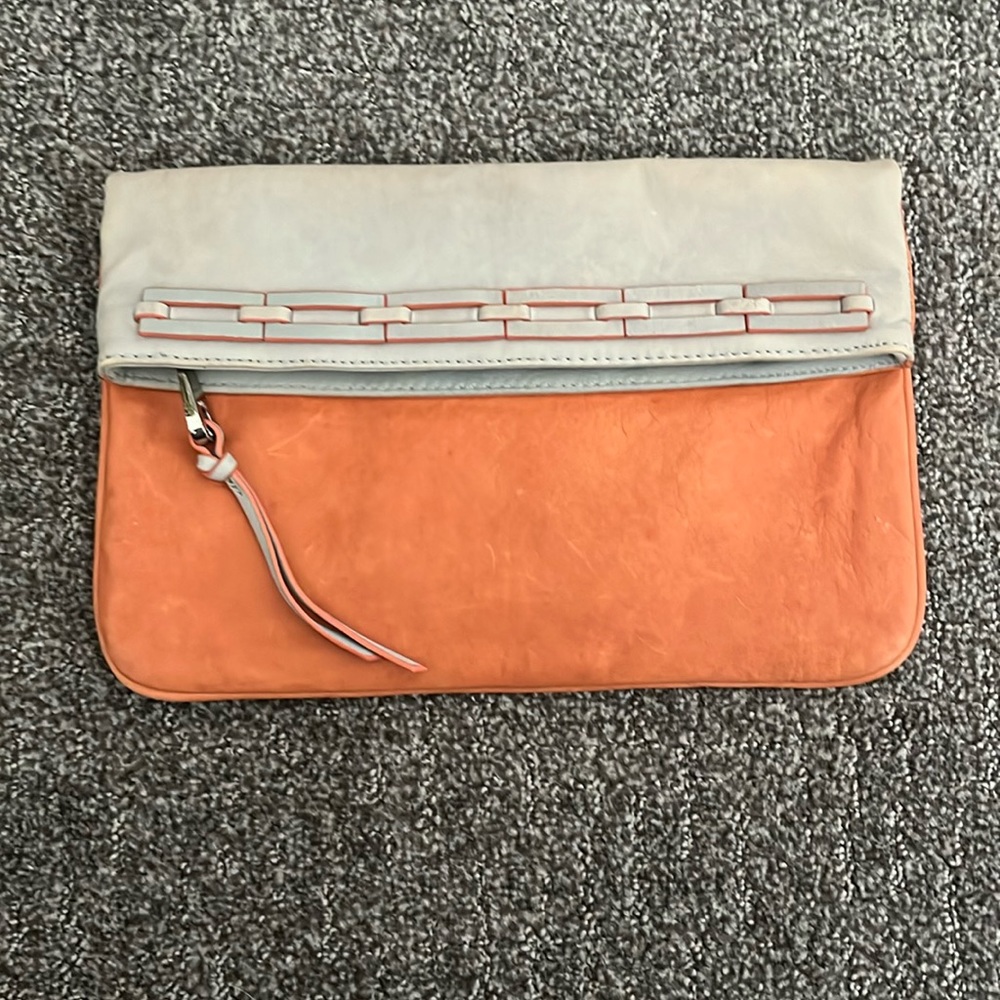 Joelle Hawkens envelope clutch, orange and cream color, good condition.